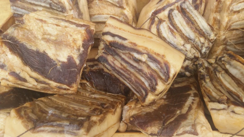 Kusky uzené vepřové bříško z plemene mangalica s viditelnými vrstvami tuku.